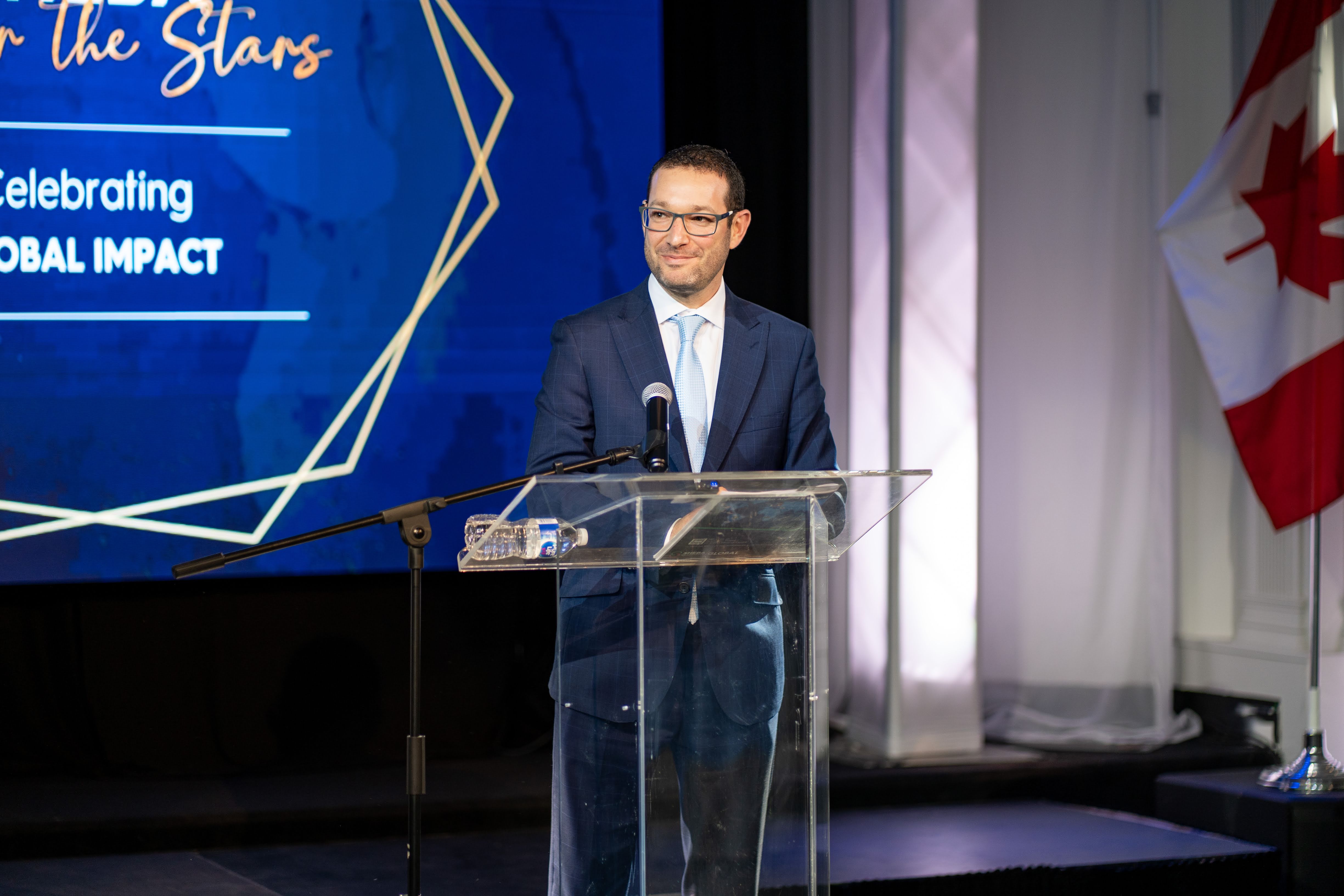 Idan Goldberger speaking at a philanthropic event